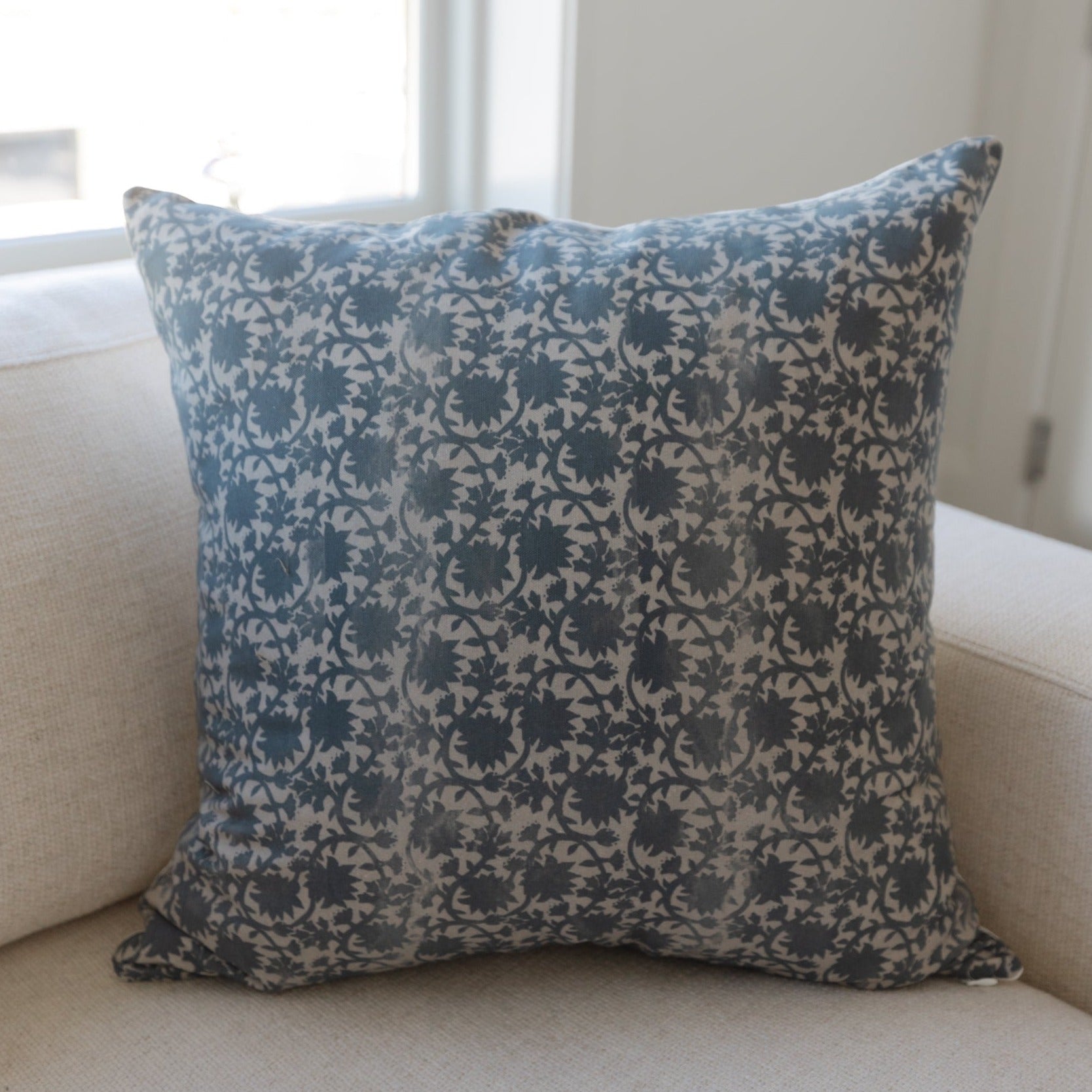 Square throw pillow with blue and cream damask floral pattern, 12x20 inches.