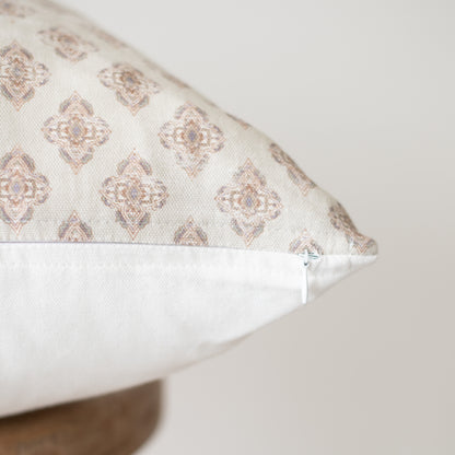 Rectangular pillow with beige and cream geometric diamond pattern and white underside, shown at an angle.