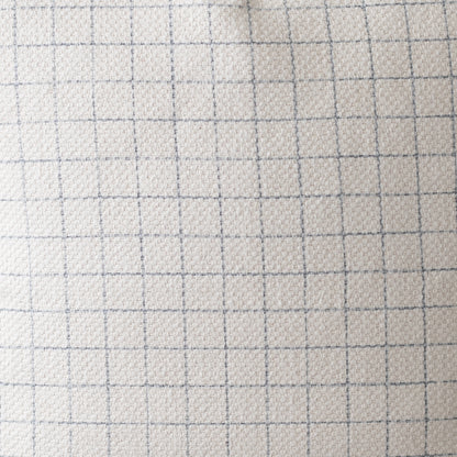 Light beige quilted fabric with gray grid pattern lines, textured surface.