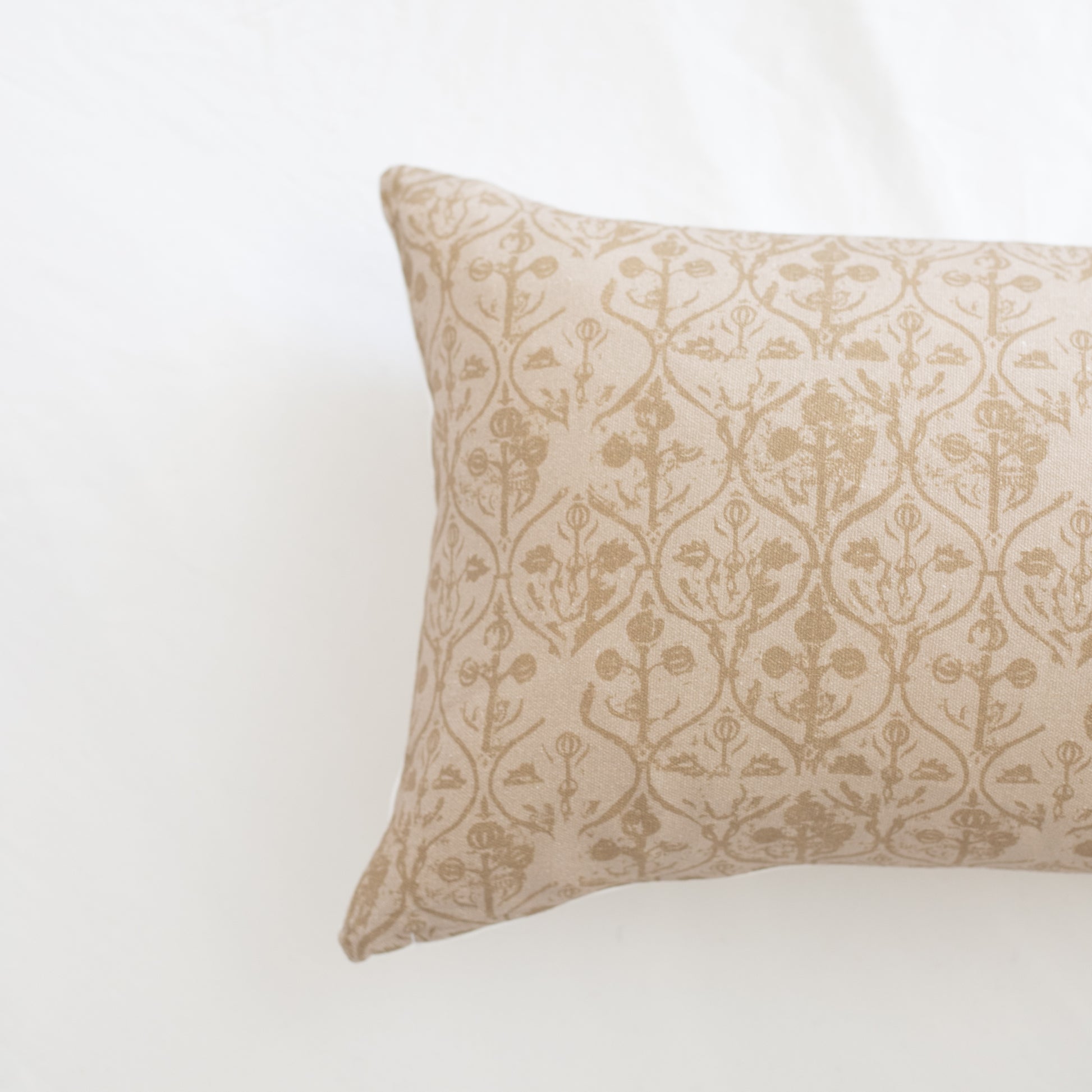 Rectangular pillow with cream and beige damask floral pattern throughout.