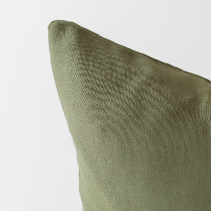 Olive green pillow cover with textured weave fabric in close-up view.