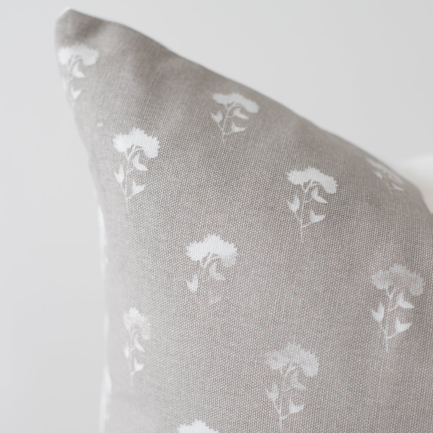 Gray 18-inch pillow with white umbrella pattern repeat throughout fabric.