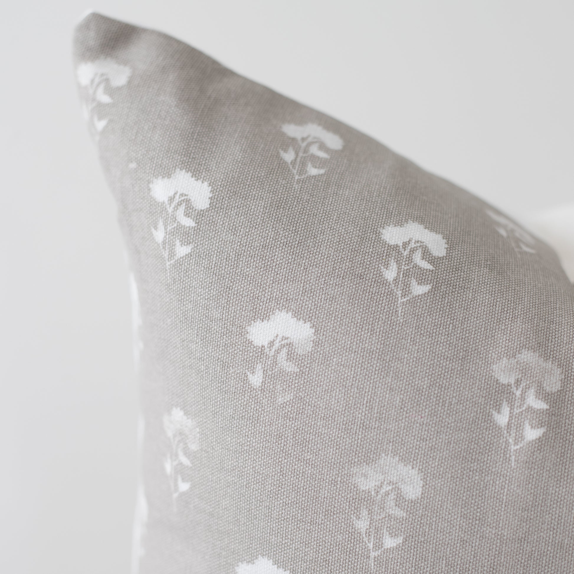 Gray 18-inch pillow with white umbrella pattern repeat throughout fabric.