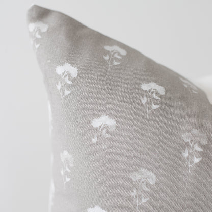 Gray 18-inch pillow with white umbrella pattern repeat throughout fabric.