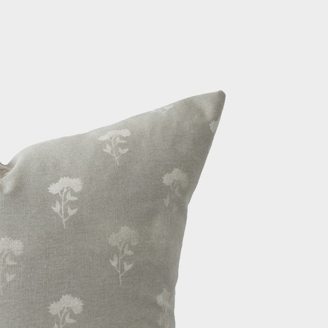 Gray pillow with white floral botanical pattern throughout.