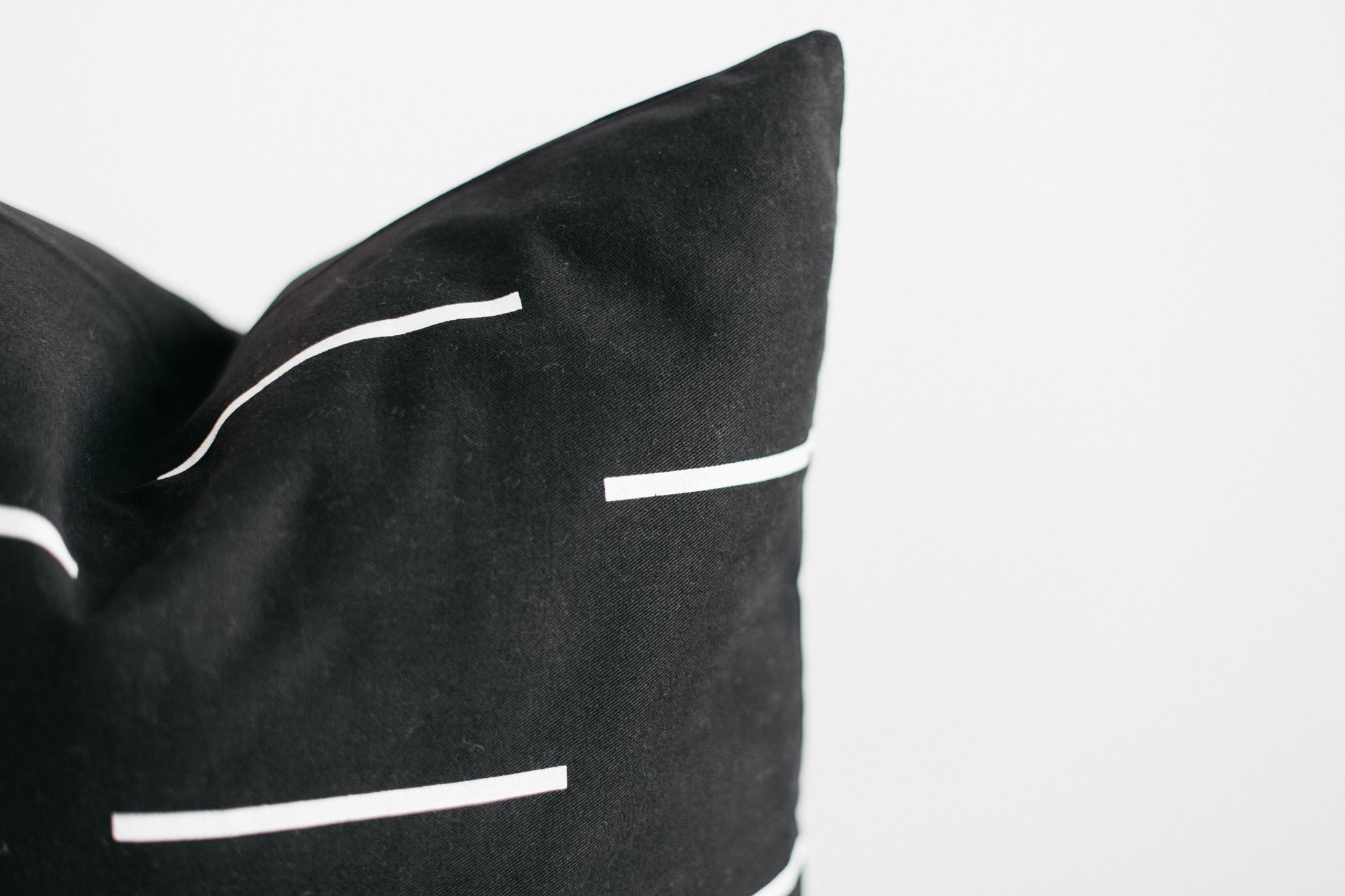 Black cylindrical storage organizers with white stripe detailing and curved handles.