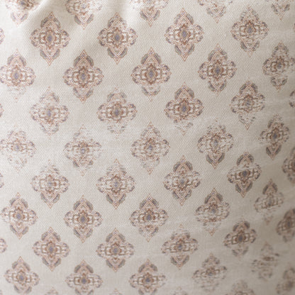 Four cream pillows with repeating taupe geometric diamond medallion pattern.