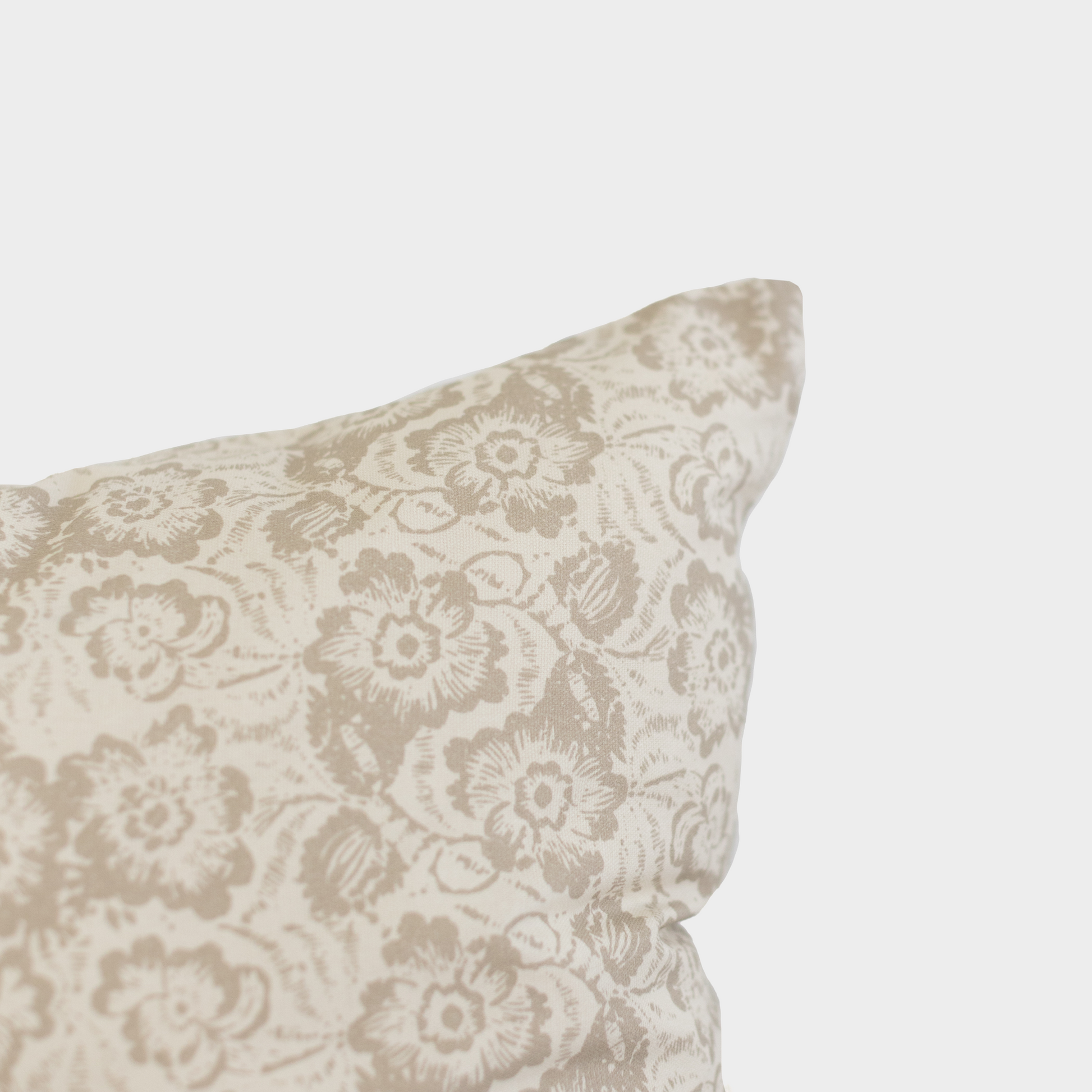 Beige pillow cover with damask floral pattern in cream and taupe tones.