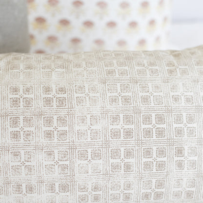 Rectangular lumbar pillow with cream and beige grid pattern texture.