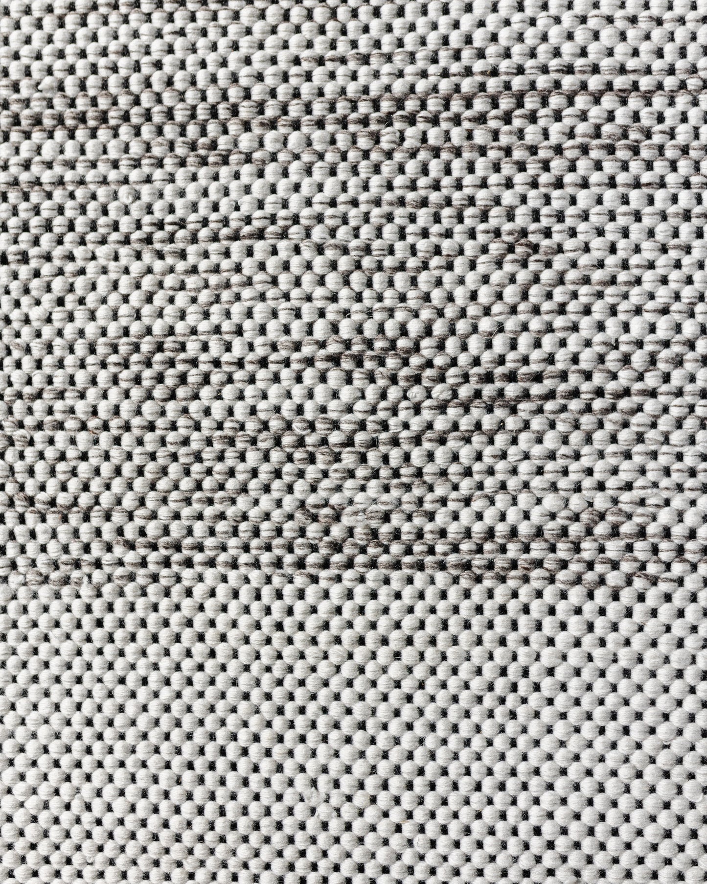 Cream and gray textured outdoor rug with dense woven pattern, 5x7 size.
