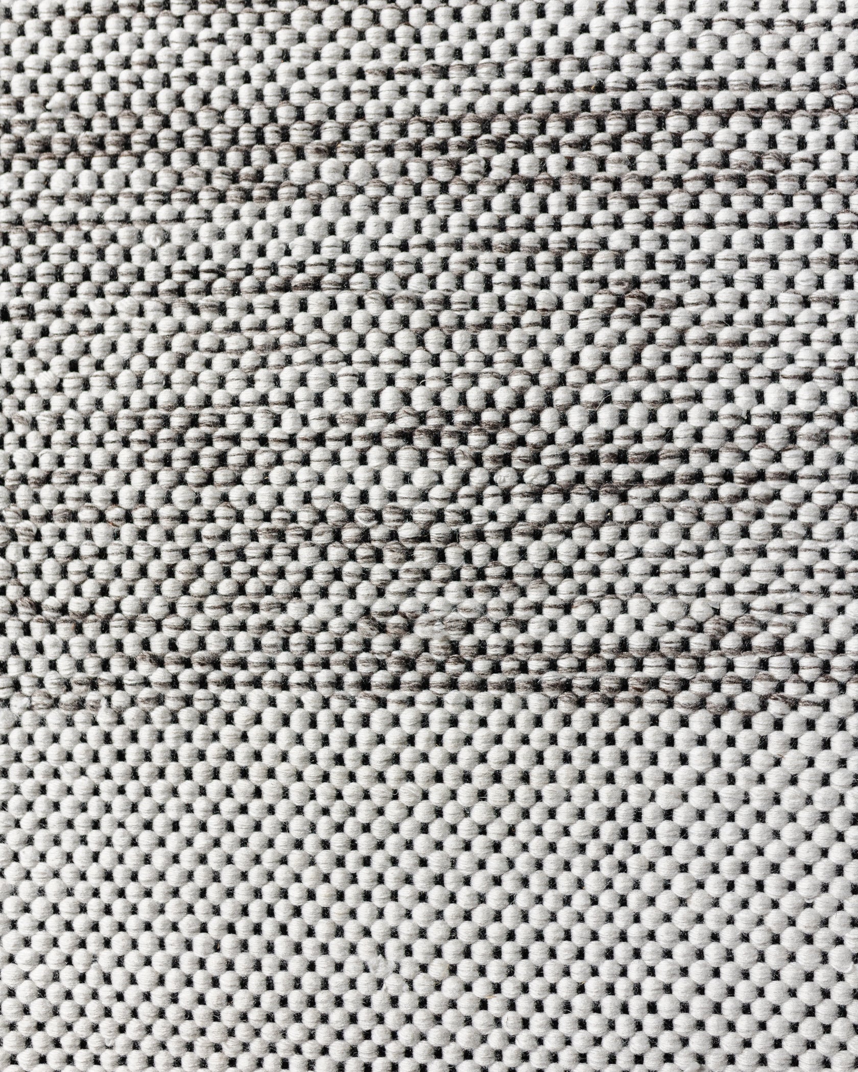 Cream and gray textured outdoor rug with dense woven pattern, 5x7 size.