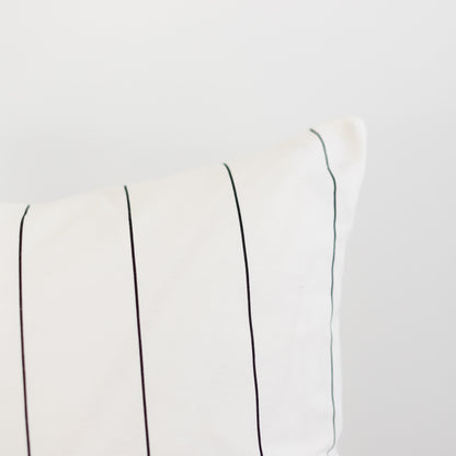 Cream-colored fabric with evenly spaced vertical pin stripes in black and gray tones.