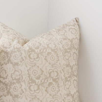 Cream pillow cover with taupe damask floral pattern, shown in corner detail view.