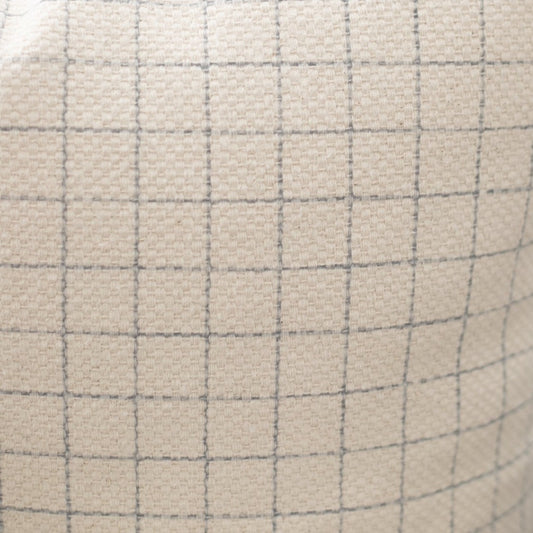 Beige lumbar pillow with gray grid pattern and quilted texture.