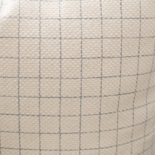 Beige lumbar pillow with gray grid pattern and quilted texture.