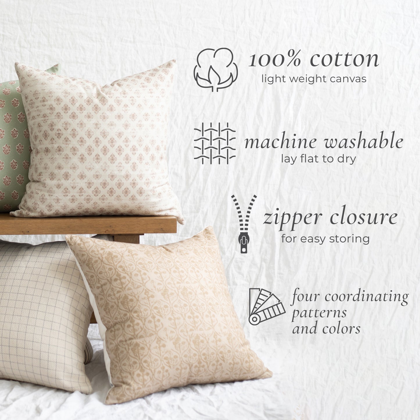 Four cotton throw pillows in coordinating geometric patterns displayed on a bed and wooden shelf.