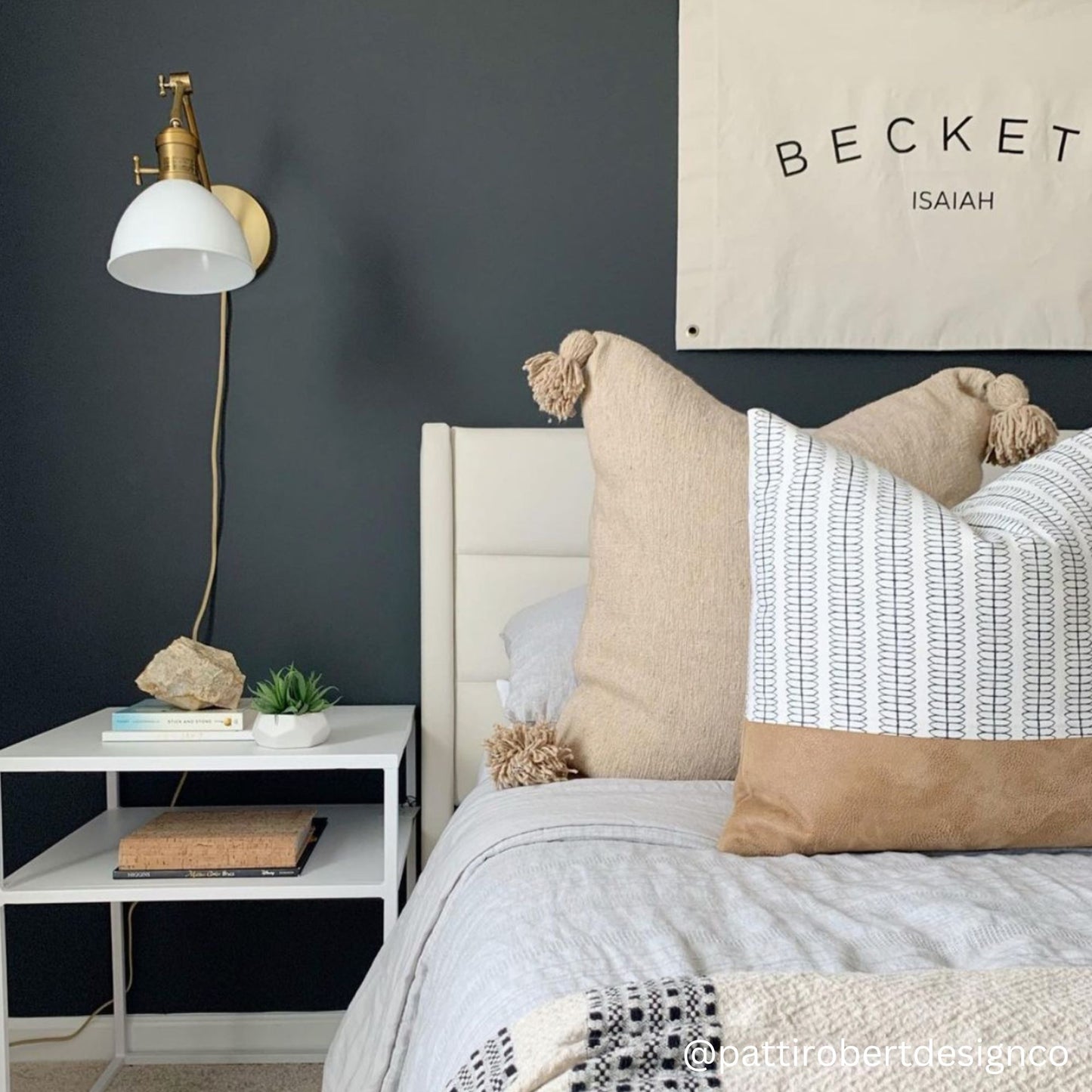 Brass floor lamp with white dome shade and adjustable arm in bedroom setting.